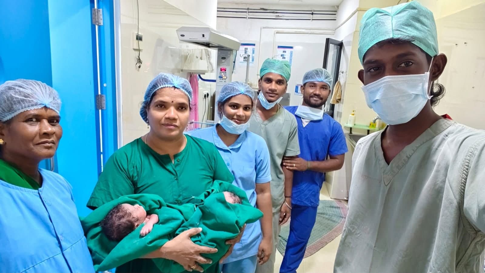 Care team in the delivery suite with a newborn
