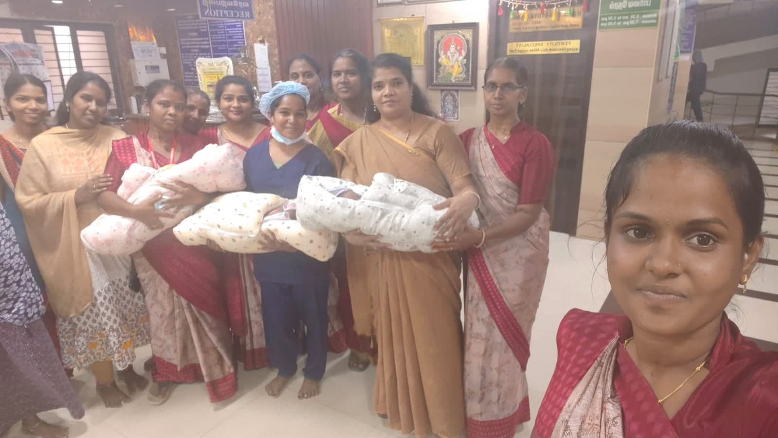 Families and staff holding newborn babies at the centre